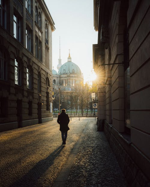 Free Silhouette of a Man Walking in the Alley Toward the Berlin Cathedral, Berlin, Germany  Stock Photo