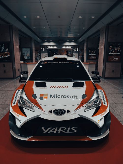Free Front view of a Toyota Yaris rally car on display, showcasing motorsport branding. Stock Photo