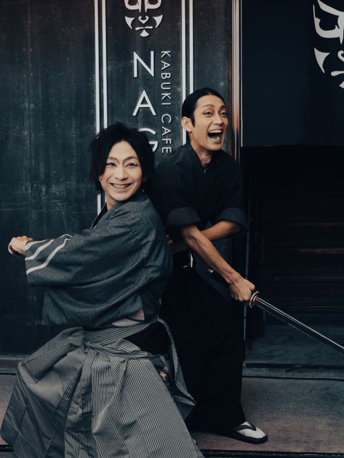 Free Two Kabuki actors smiling and posing with swords outside a Kabuki Café in Nagoya, Japan. Stock Photo