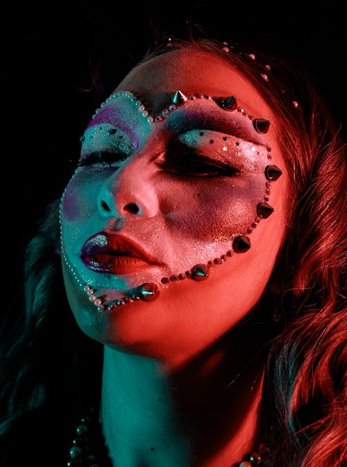 Woman with Painted Face in Red Light