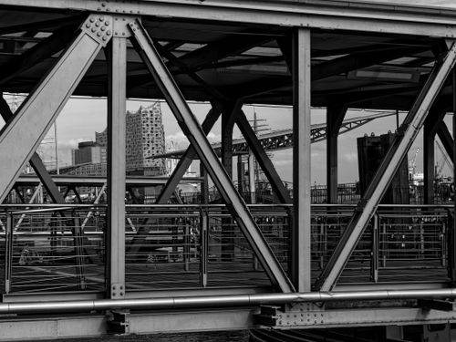 Free Black and white view of Hamburg's industrial bridge with Elbphilharmonie in the background. Stock Photo