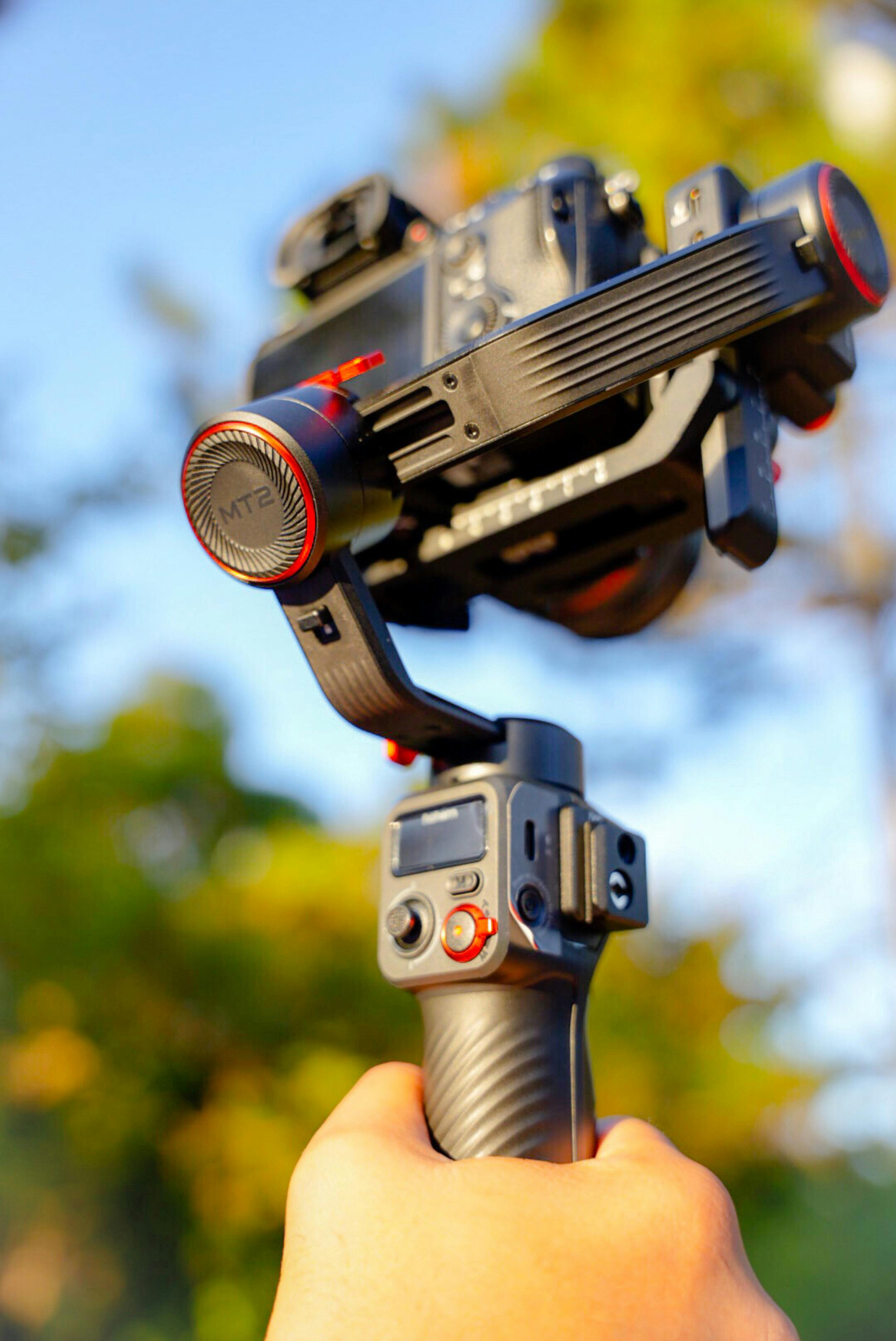 hand holding camera on tripod