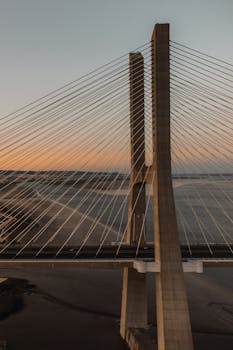 A stunning view of the Vasco da Gama Bridge in Lisbon captured at sunset, showcasing modern architecture.
