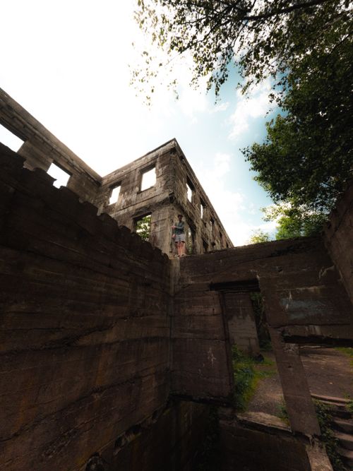 Free Explore a captivating view of ancient ruins surrounded by lush greenery under a vibrant sky. Stock Photo