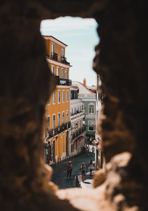 Cobblestone Street behind Stone Window Opening in Lisbon