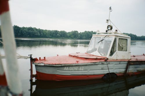 Vintage Motorboat Moored by Pier