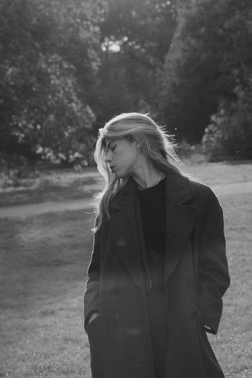 Model in Coat Posing in Park