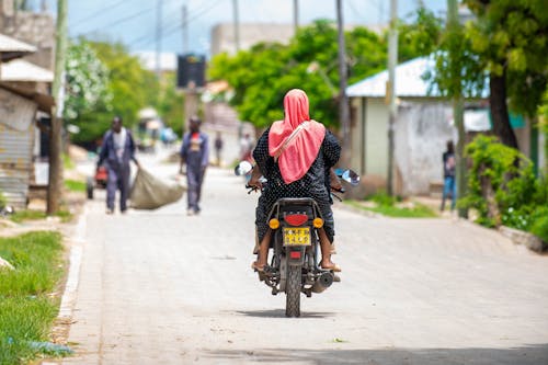 Back of a Woman Wearing a Pink Hijab Riding a Motorcycle
