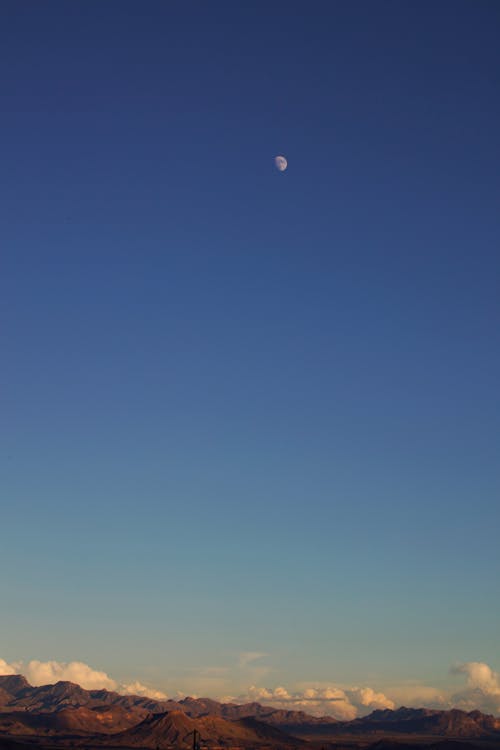 Moon High above Hills at Dusk