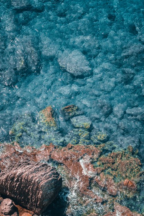 Free Stunning aerial view of the clear blue waters and rocky coastline in Bonifacio, Corsica, France. Stock Photo