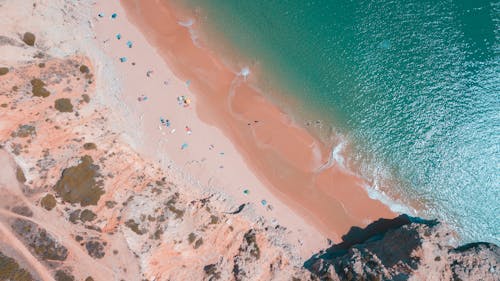 Aerial View of People Relaxing on a Sandy Beach