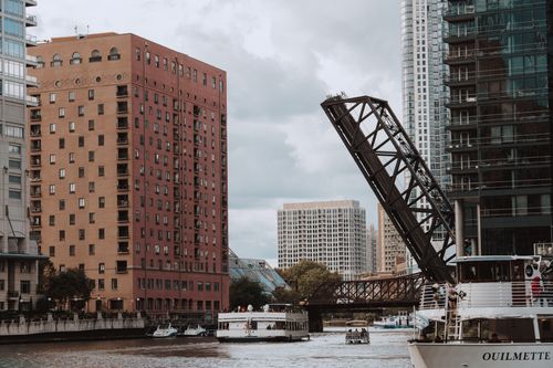 Free Chicago river scene capturing open drawbridge, buildings, and boats. Stock Photo