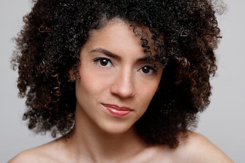 Portrait Photo of Curly-Haired Woman