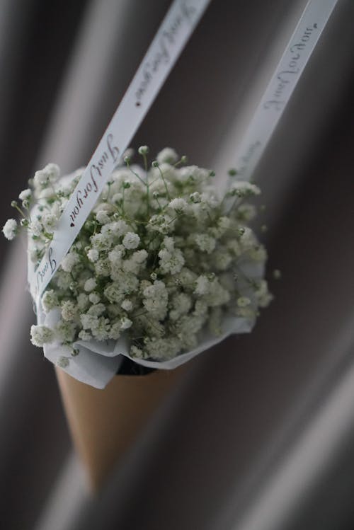 Bouquet of White Flowers Hanging on a Ribbon