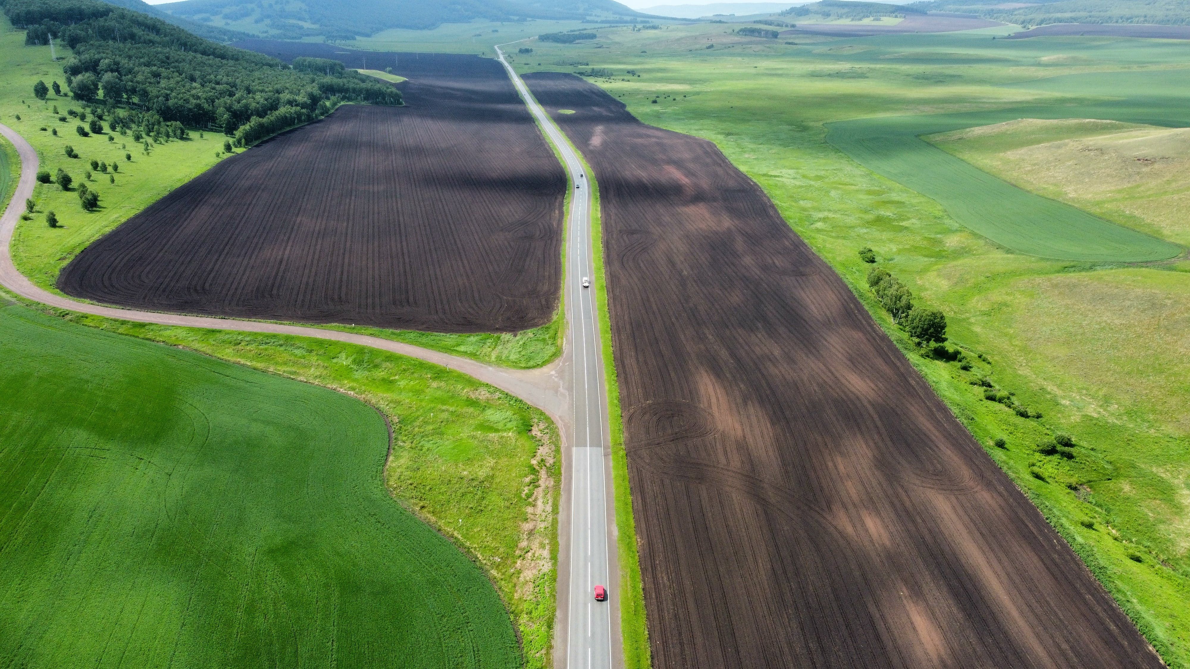 Plowed Fields by the Road From a Birds Eye View · Free Stock Photo