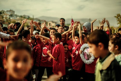Group of Smiling Children in Red T-shirts with the National Emblem of Turkey