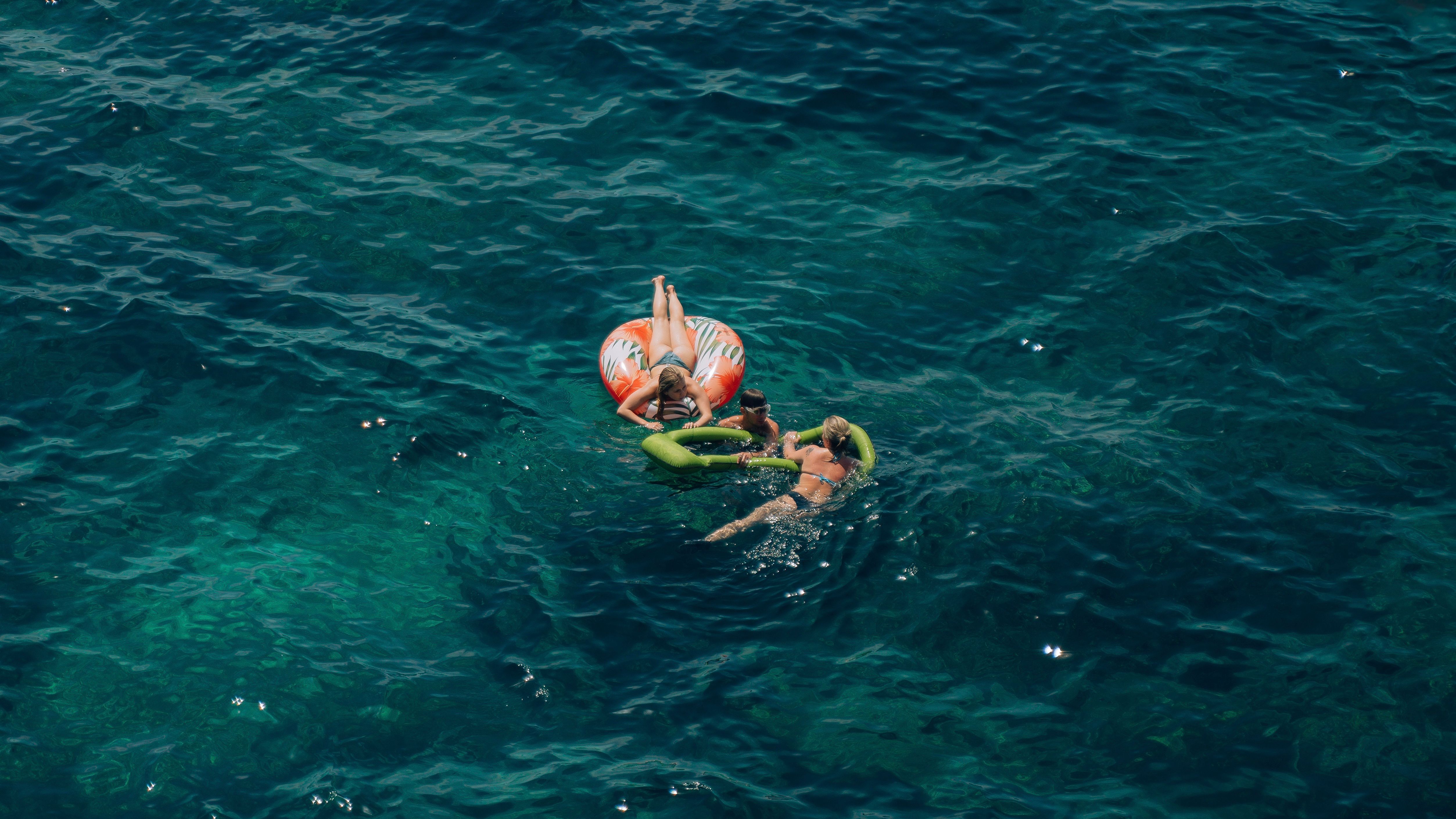 Women Swimming on Inflatable Boats · Free Stock Photo
