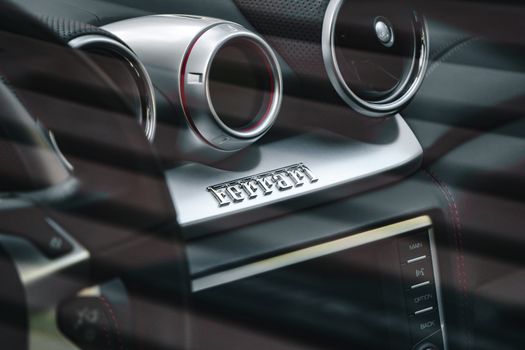 Close-up of a luxury car dashboard with sleek design and stylish controls, showcasing elegance and technology.