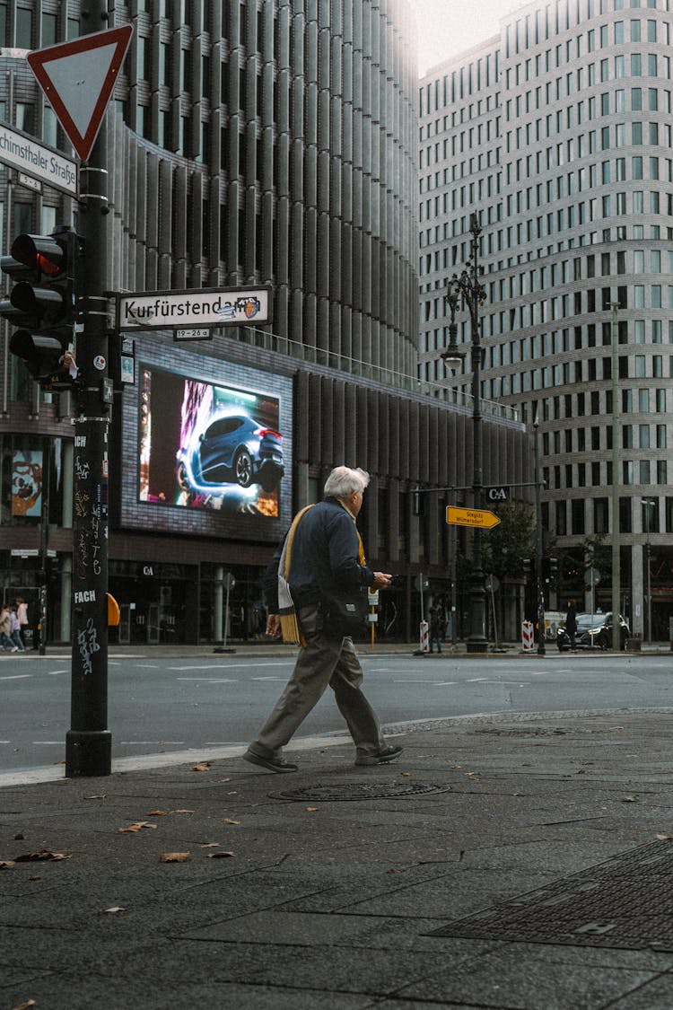 Old Man Walking On Street In City Downtown