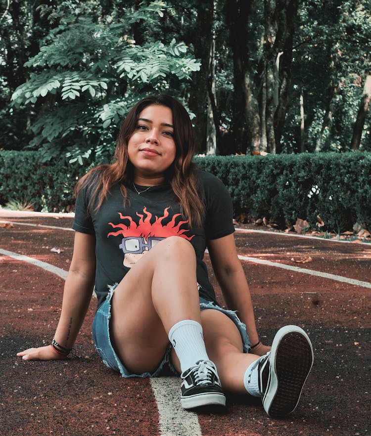 Woman Sitting On Athletics Track