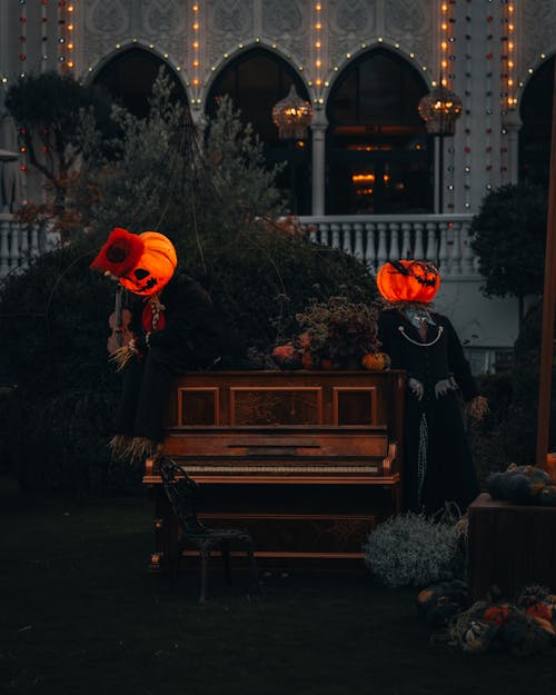 People with Pumpkins Heads and with Piano for Halloween