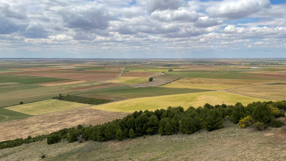 Expansive aerial view of Urueña's rural farmland, showcasing vibrant fields and open skies.