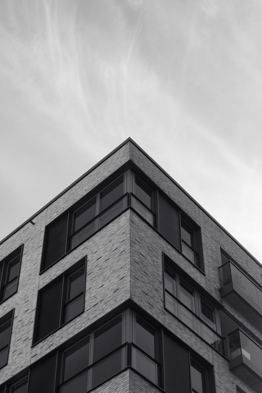 Low-angle view of a modern residential building in Hamburg with a clear sky background.