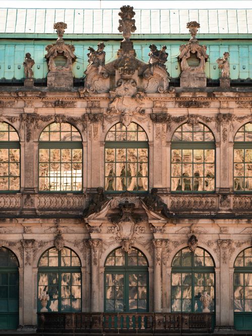 Free Stunning baroque facade with detailed sculptures and arched windows. Stock Photo