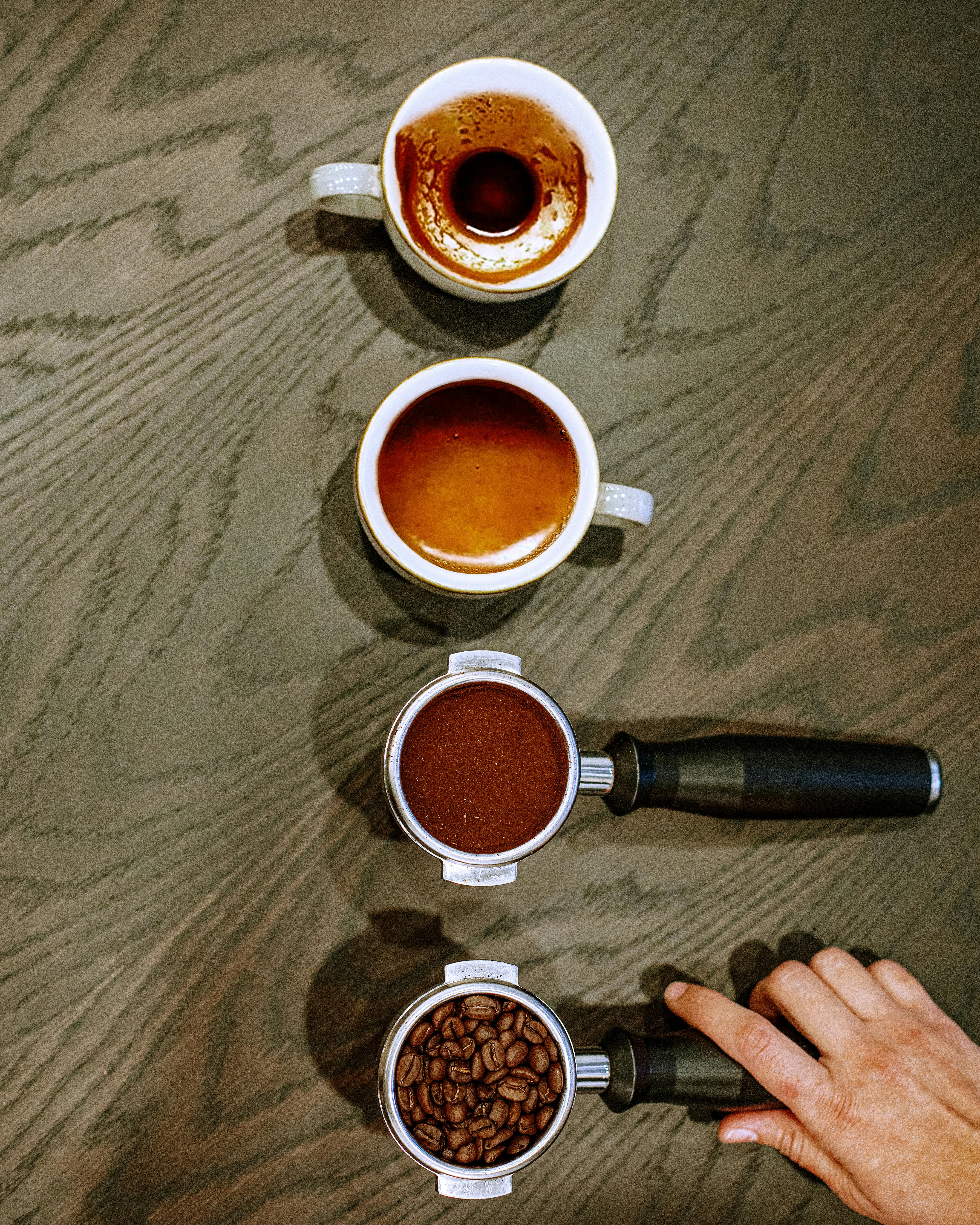 Top view of coffee cups and portafilters illustrating the coffee making process. Captured in Baku, Azerbaijan.