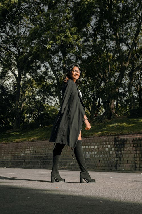 Woman Standing in Black Coat and Boots