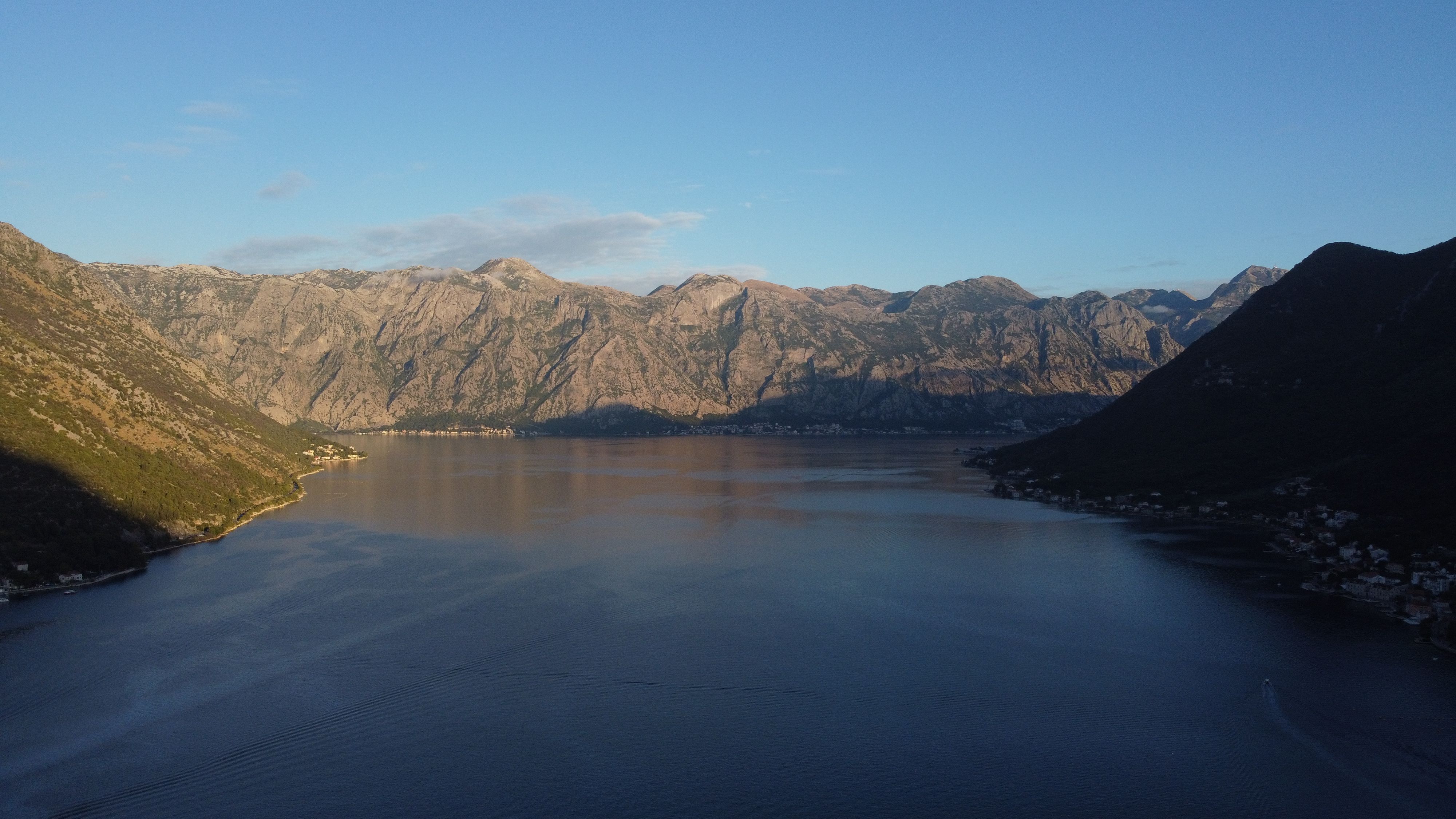 A breathtaking aerial view of Kotor Bay with mountains and blue skies in Montenegro. A breathtaking aerial view of Kotor Bay with mountains and blue skies in Montenegro.