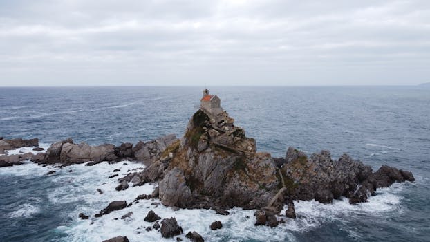Aerial view of St. Nedjelja Church on a rocky island off the coast of Montenegro.