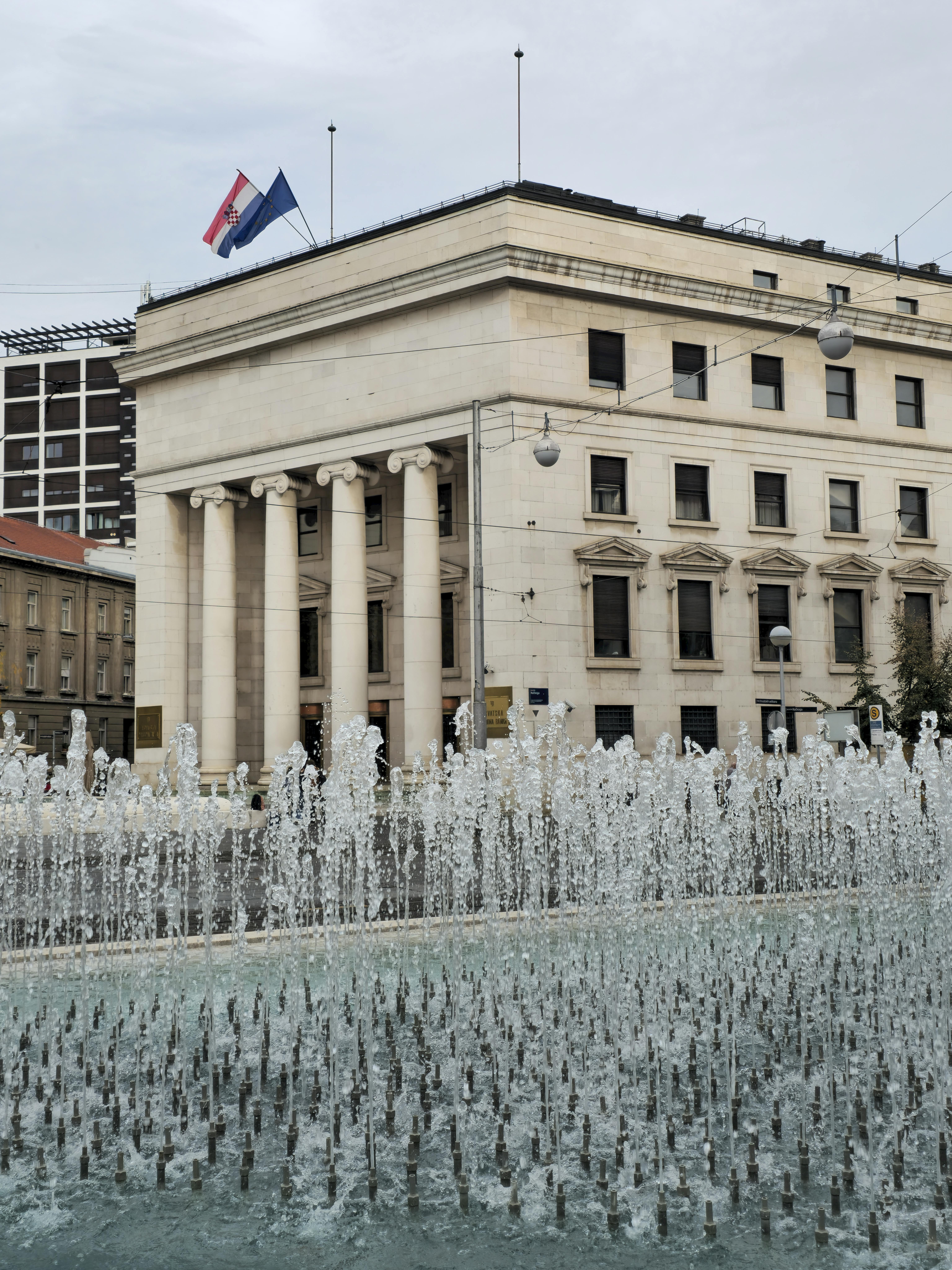 Beautiful view of Croatian National Bank with an elegant fountain in Zagreb, Croatia.