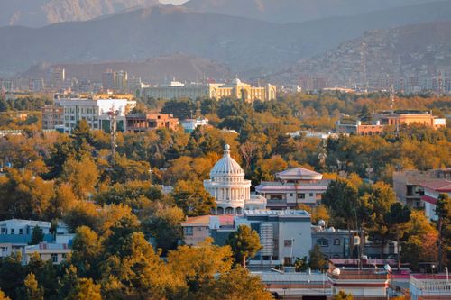 Free Explore Kabul's urban landscape from above, highlighting its iconic architecture against a mountainous backdrop at sunset. Stock Photo