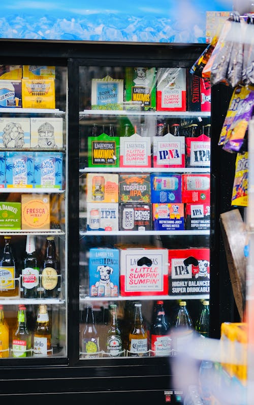 Boxes and Bottles of Alcohol in Fridge in Shop