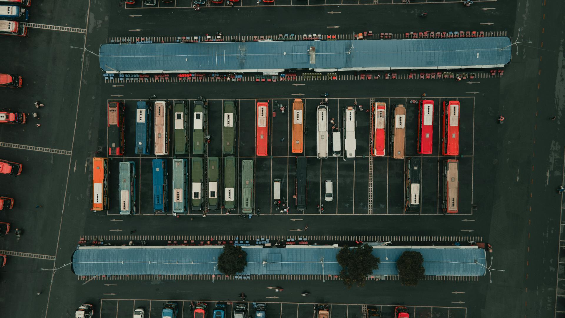 Drone view of colorful buses parked at a bus terminal in Ho Chi Minh City.