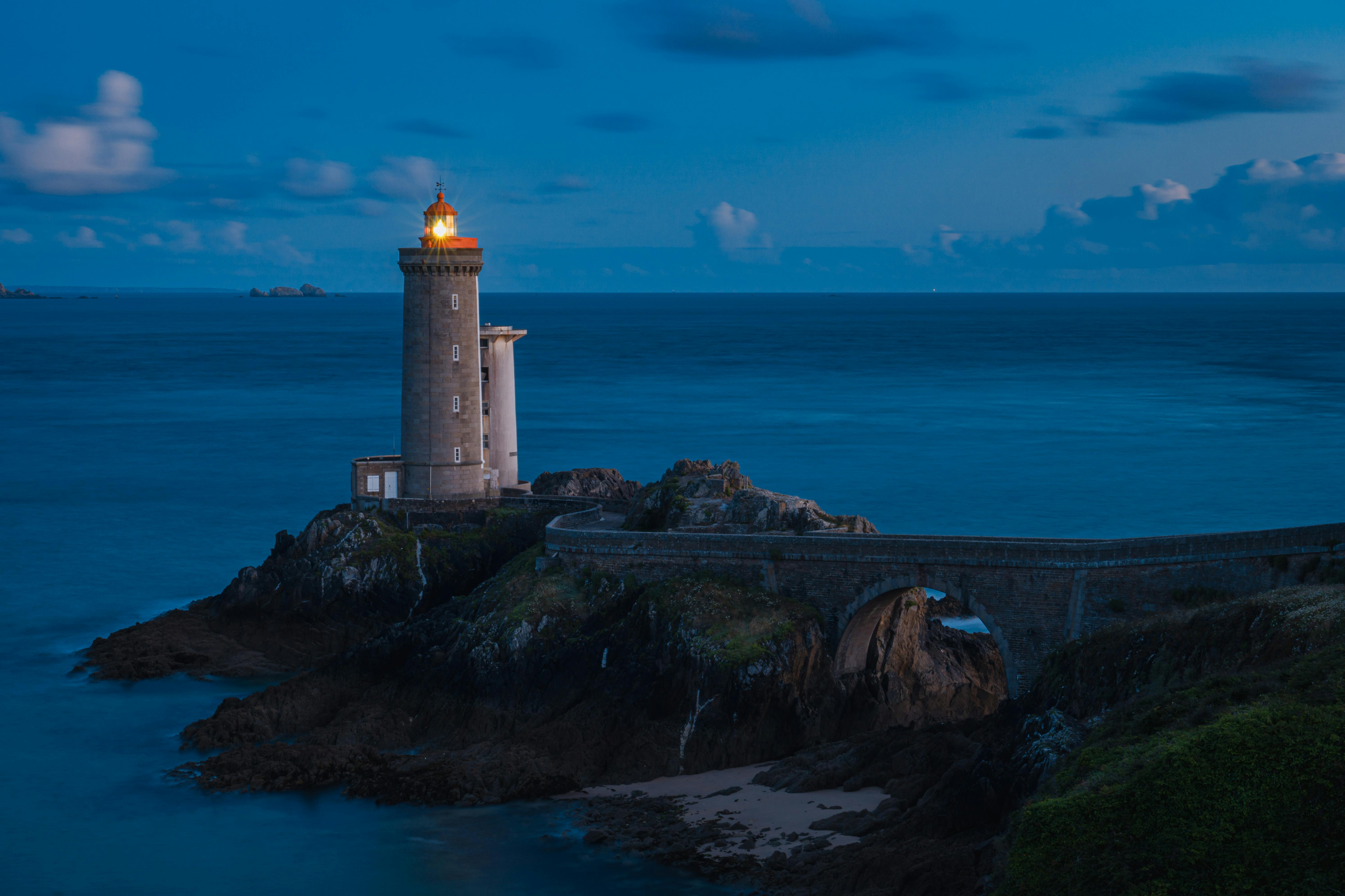 Beautiful coastal scene showcasing the iconic Petit Minou Lighthouse at dusk in Brittany, France.