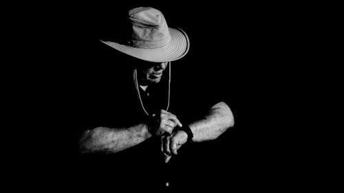 Black and White Photo of a Man in Cowboy Hat 