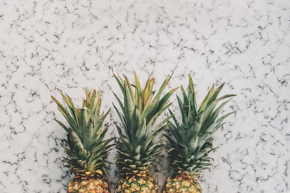 3 Pineapple Fruit on White and Grey Sand