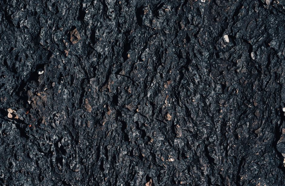 Detailed texture of volcanic rock with a rough, earthy surface suitable for backgrounds.