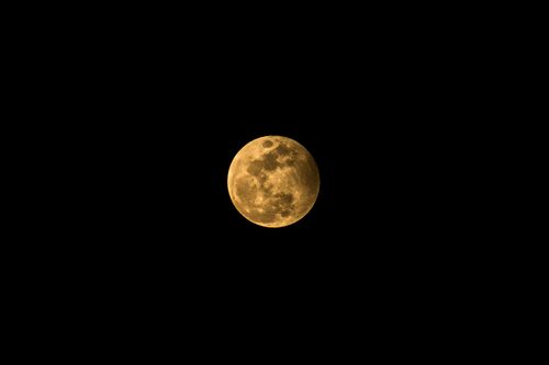 Free A stunning full moon glowing yellow against a dark night sky in Aracati, Brazil. Stock Photo