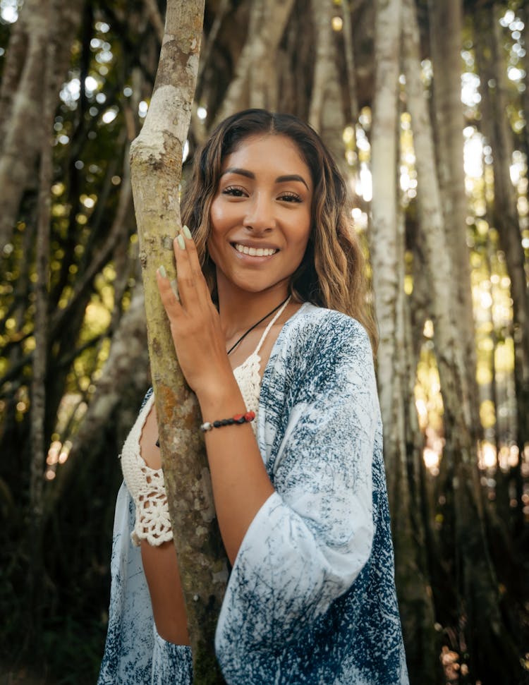 Portrait Of Smiling Woman Among Trees