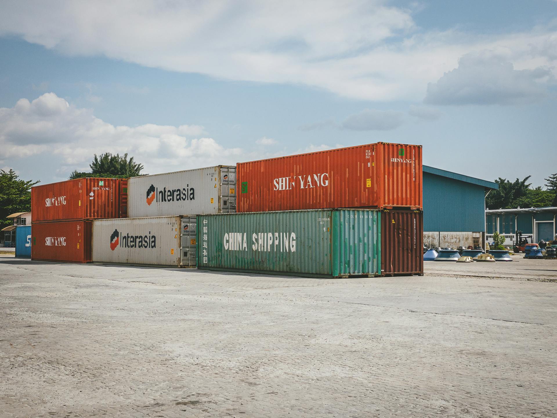 Stacked shipping containers in Ipoh, Malaysia, showcasing global trade and logistics.