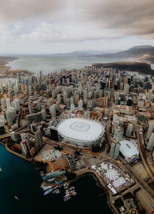 Free Stunning aerial view of Vancouver, BC showing the city skyline, waterfront, and prominent stadium. Stock Photo