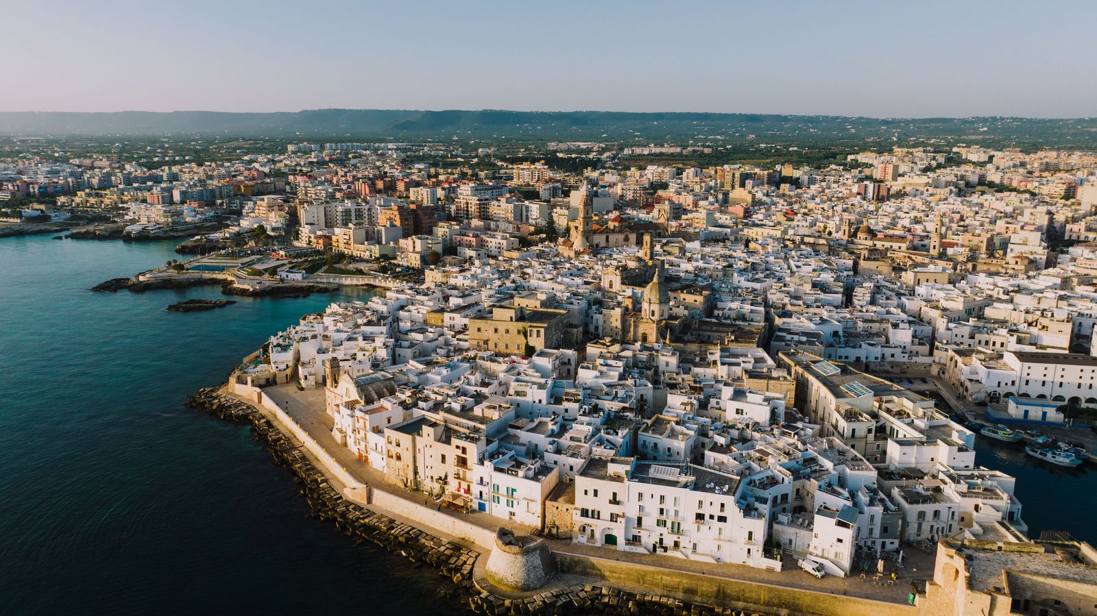 Aerial view of a coastal old town at golden hour — photo by K on Pexels