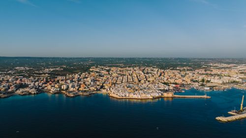 Free Aerial shot of Monopoli, Apulia, Italy, showcasing the seaside town's architecture and harbor. Stock Photo