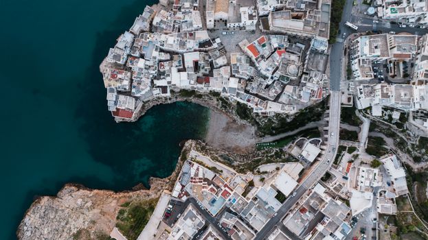 Drone shot capturing the unique architecture and coastline of Polignano a Mare, Italy.