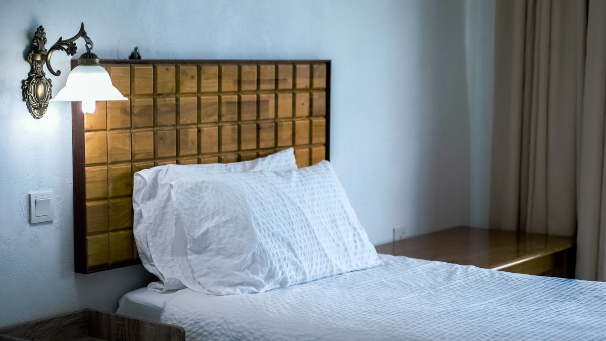 Made hotel bed with pillows in a bright guest room