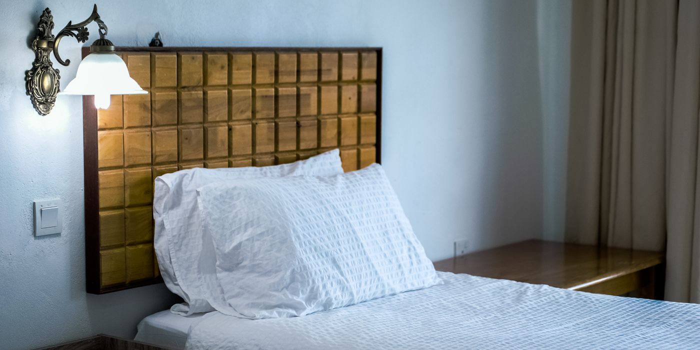 Made hotel bed with pillows in a bright guest room