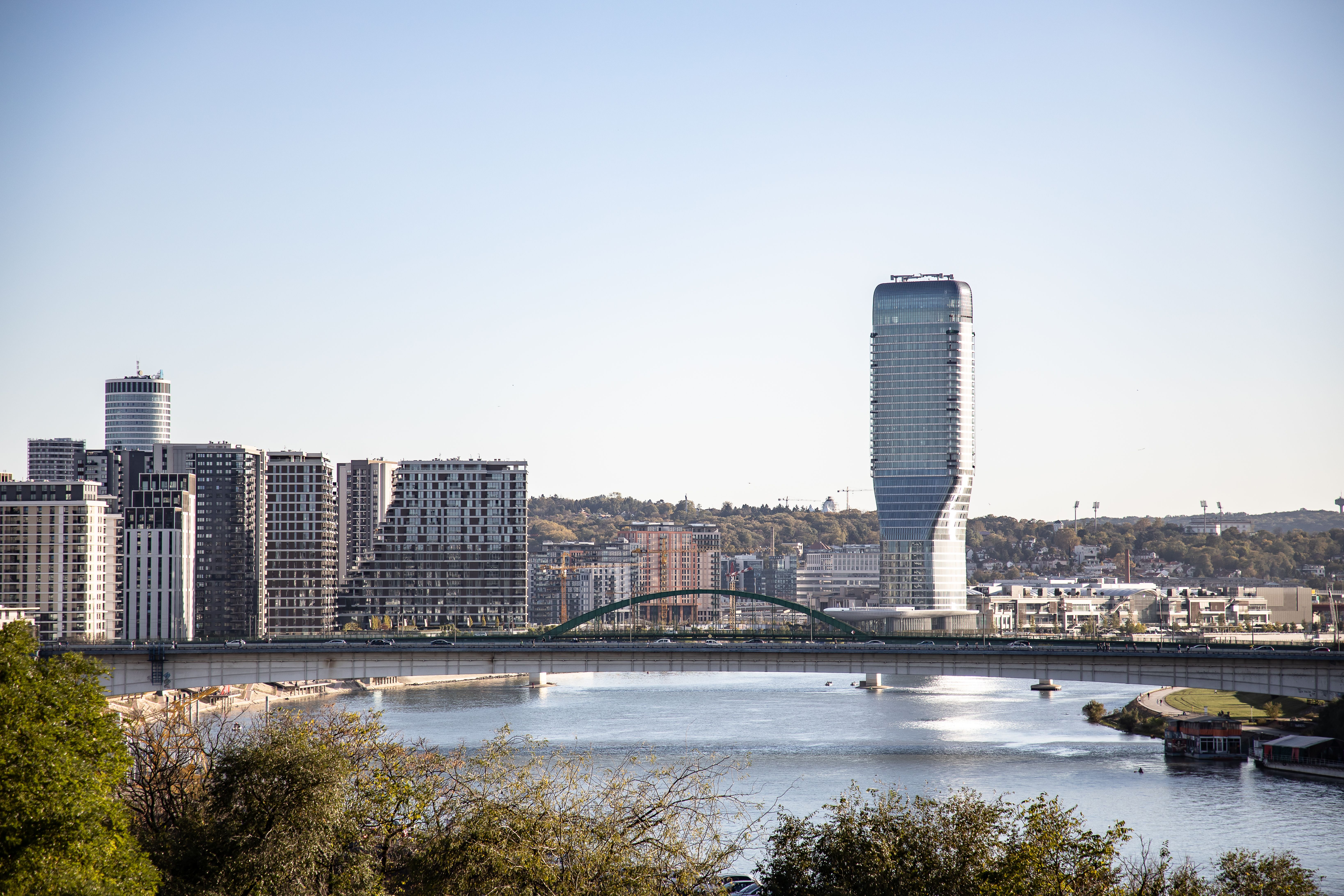 A stunning view of Belgrade's skyline with the Belgrade Tower by the river under a clear sky.